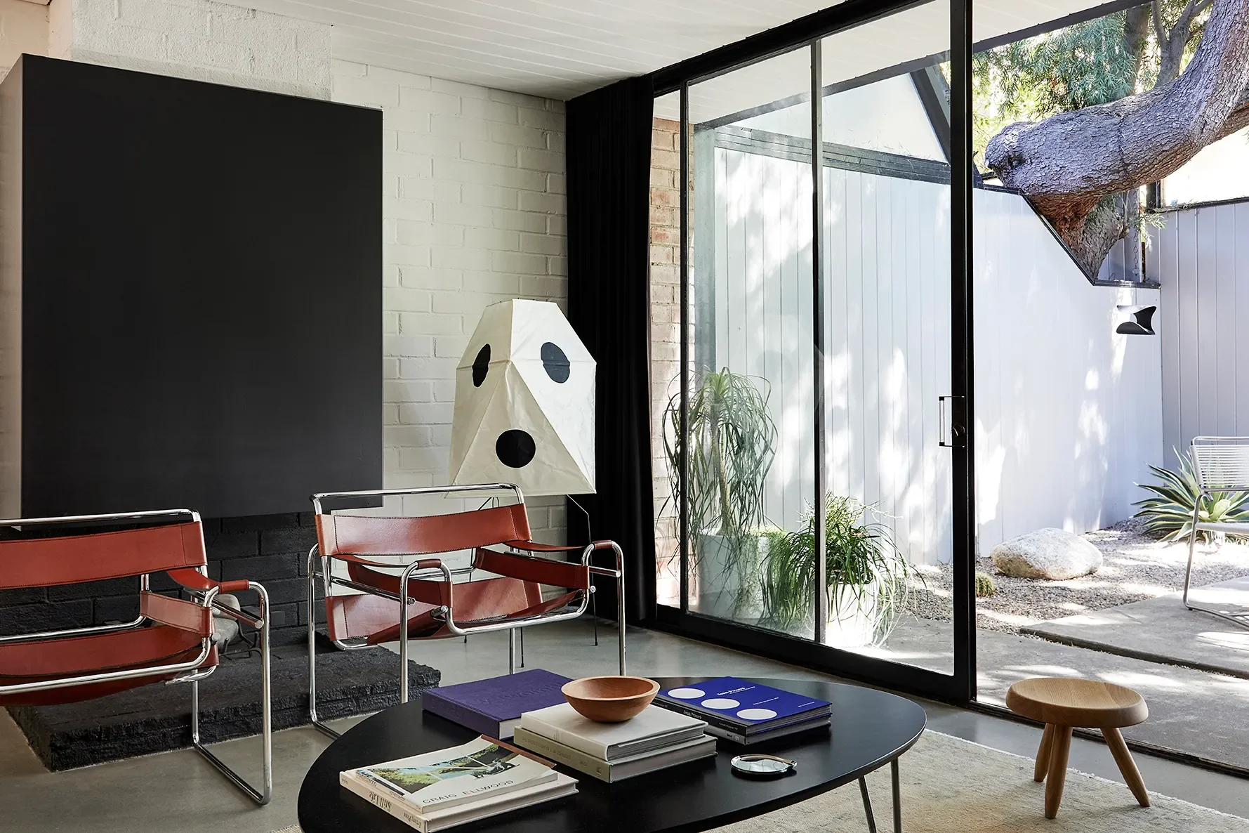 living room with Noguchi light and red Wassily chairs